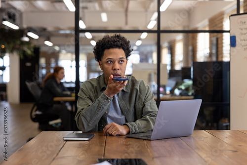 Young Man in Office Using Voice Command on Phone