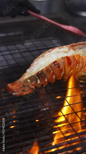 Grilling lobster tail over flames outdoor kitchen culinary art gourmet experience close-up view seafood delight for summer feasts