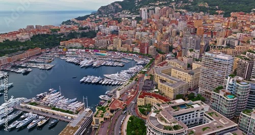 Birds eye aerial view of traffic in Monte Carlo, Monaco. Famous formula one Grand Prix Circuit. Aerial view of the city of Monaco. Establishing shot showcases luxury yachts moored in Monaco bay
