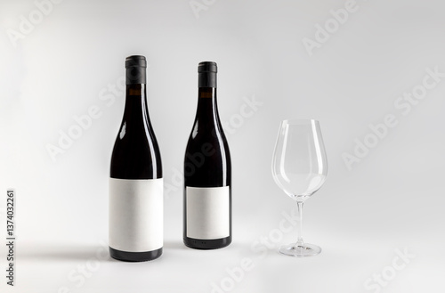Mockup of classic bottle of red wine garnacha, front and back view, with glass of wine, on white background with copyspace, 750 ml, real photo