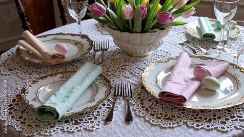 Elegant table setting with tulips and pastel napkins  