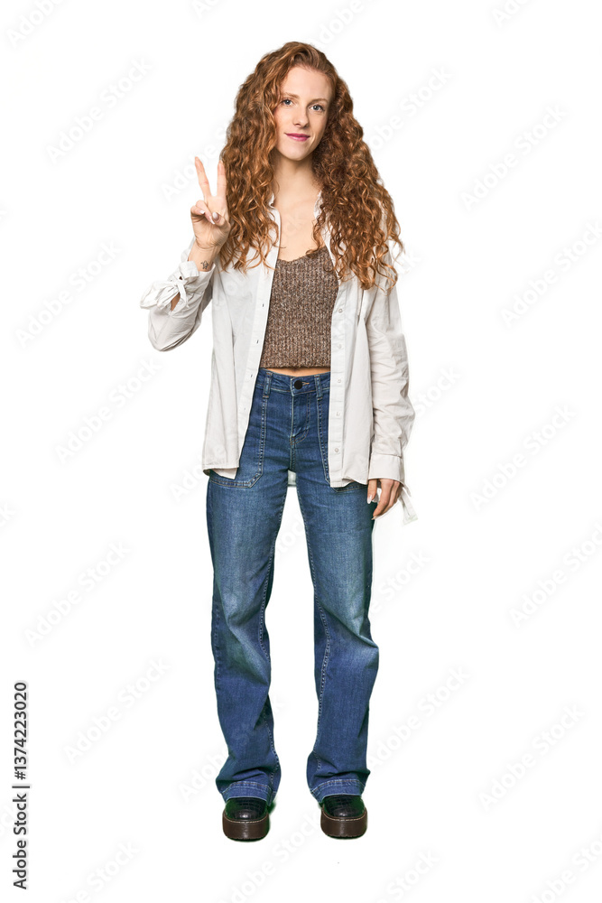 Full-body redhead portrait joyful and carefree showing a peace symbol with fingers. Full-body redhead portrait joyful and carefree showing a peace symbol with fingers.