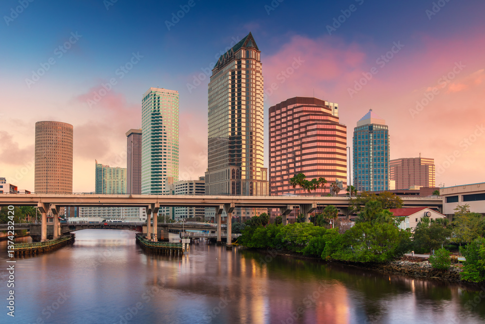 Tampa, Florida, USA. Cityscape image of Tampa, Florida with reflection of the city skyline in the water at beautiful sunrise.