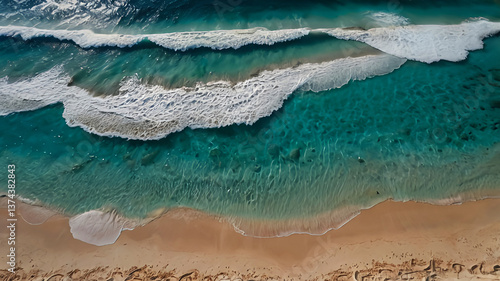Azure Waves Meet Golden Sands: A Serene Aerial View of Ocean's Embrace on a Sun-Kissed Shoreline.