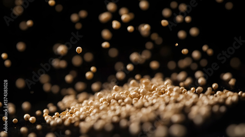 A close-up of Amaranth seeds scattered in a dark environment, showing their smooth, fine texture and small size in cream color.