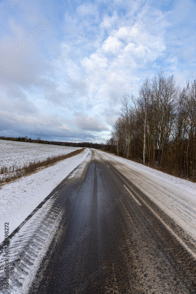 a dirty slippery road in winter after a snowfall a dirty slippery road in winter after a snowfall