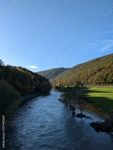 Blue clear sky landscape Ardennes, Belgium with river meadows and forest