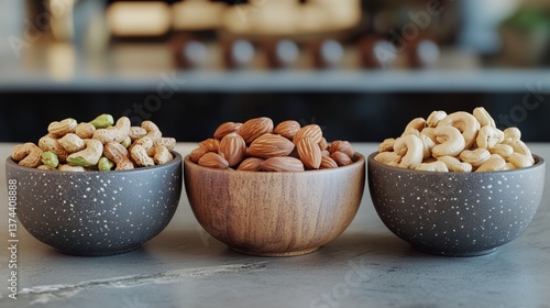 Nutrient-rich Selection of Nuts Displayed in Attractive Bowls on a Marble Cou...