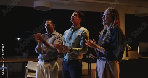 Wallpaper Mural Business diverse team clapping and celebrating success during night meeting at office Torontodigital.ca