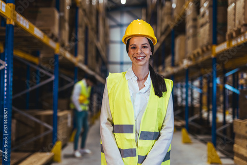 Obraz na płótnie Smiling Woman Wearing Safety Gear in a Warehouse Environment for Logistics w salonie