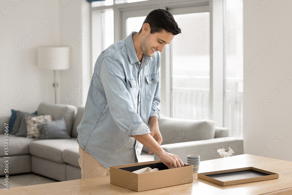 Man unpacks, or prepare package for sending using reliable transporting services. E-commerce client enjoy purchased goods, open parcel box, take out items feel satisfied with quality, express delivery Man unpacks, or prepare package for sending using reliable transporting services. E-commerce client enjoy purchased goods, open parcel box, take out items feel satisfied with quality, express delivery