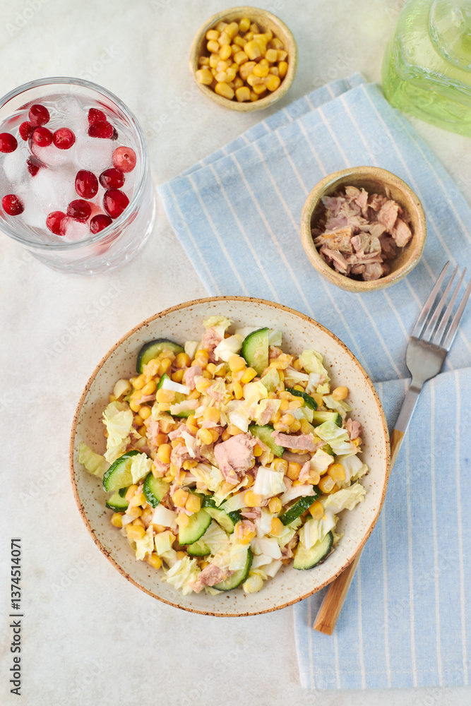 Fresh salad with tuna, corn, cucumber, and red berries drink Fresh salad with tuna, corn, cucumber, and red berries drink