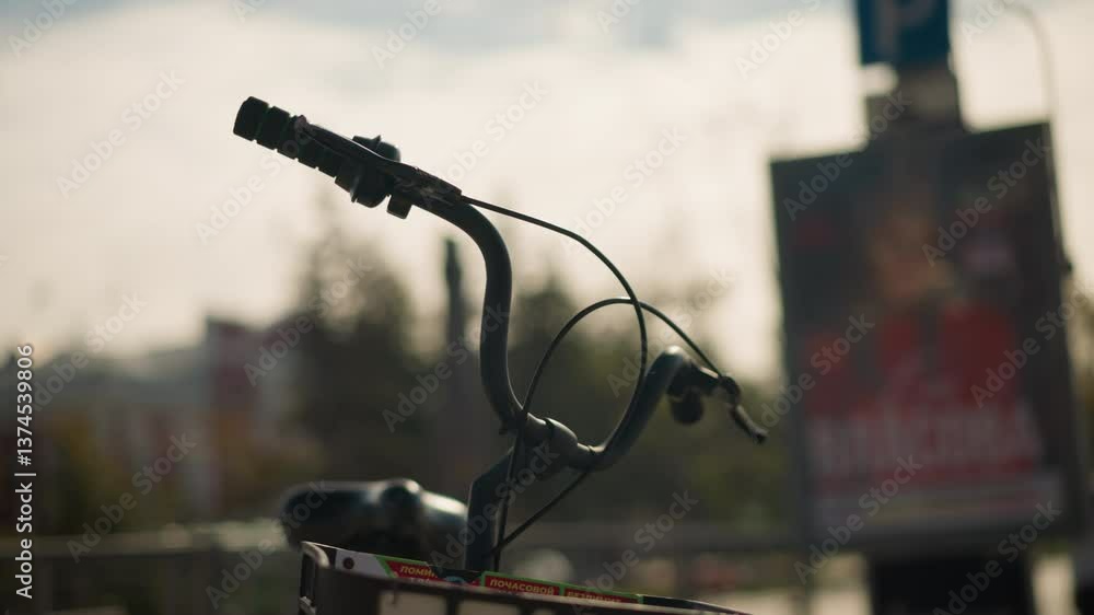 Close-up of bicycle handlebars with green accents, brake lever, and control cables, set against a vibrant city background. Captures urban cycling gear and outdoor transportation Close-up of bicycle handlebars with green accents, brake lever, and control cables, set against a vibrant city background. Captures urban cycling gear and outdoor transportation