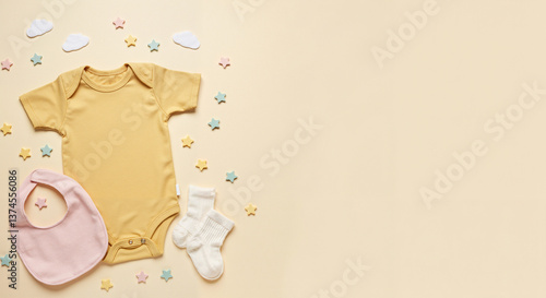 Baby clothing items arranged with playful stars on a pastel background  