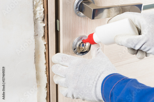 The master lubricates the door lock design, close-up