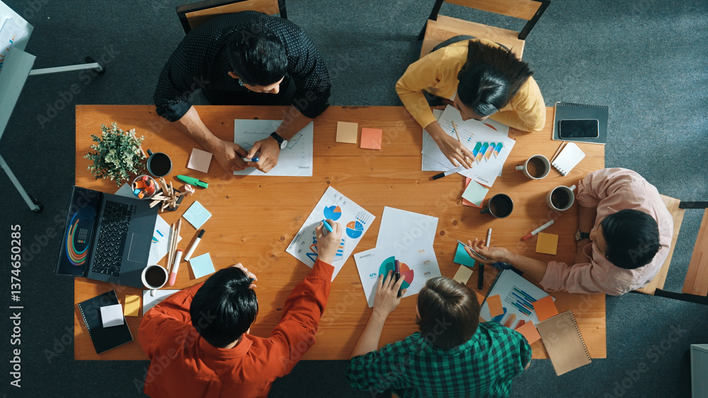 Top down aerial view of business team making scrum task board at meeting room. Group of people writing at paper and sticky notes for making kanban board to manage work flow. Top view. Convocation.