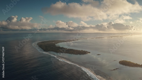 Wallpaper Mural An aerial perspective captures a stunning coastal landscape where clear blue waters meet a lush green island. Gentle waves lap against the shore under a dramatic sky filled with clouds during sunset. Torontodigital.ca