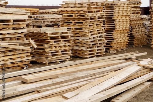 stack of wooden planks and pallets on the construction site 