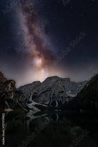 Lago di Braies, Pragser Wildsee. Beautiful night sky with Milky Way in Dolomites mountains. Epic blue lake, mountain, rocks, forest. Premium astro landscape from pure nature, Dolomiti, Alps, Italy