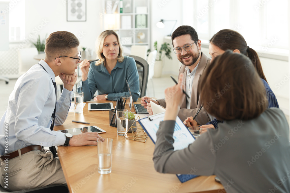 Obraz premium Coworkers working together at wooden table in office