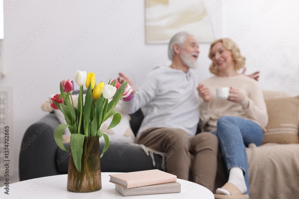 Fototapeta premium Senior man and mature woman spending time together at home, selective focus. Happy couple