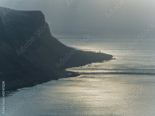 Aerial view of dramatic coastline and calm sea at sunset in Patreksfjordur, Iceland...