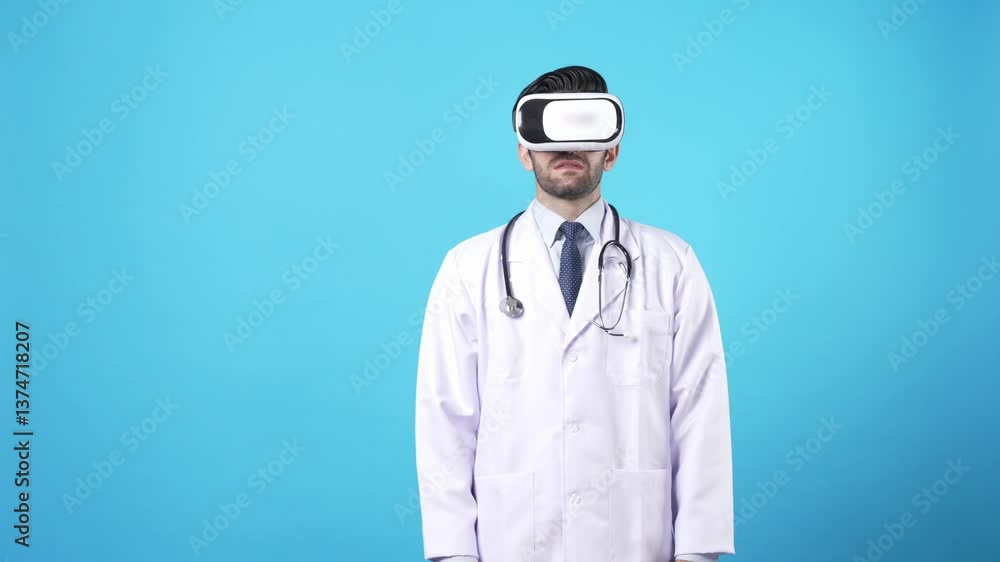 Skilled medical worker holding and moving hand to manage medical data while wearing VR headset and lab coat. Professional doctor standing at blue background and using augmented reality. Apparatus. Skilled medical worker holding and moving hand to manage medical data while wearing VR headset and lab coat. Professional doctor standing at blue background and using augmented reality. Apparatus.