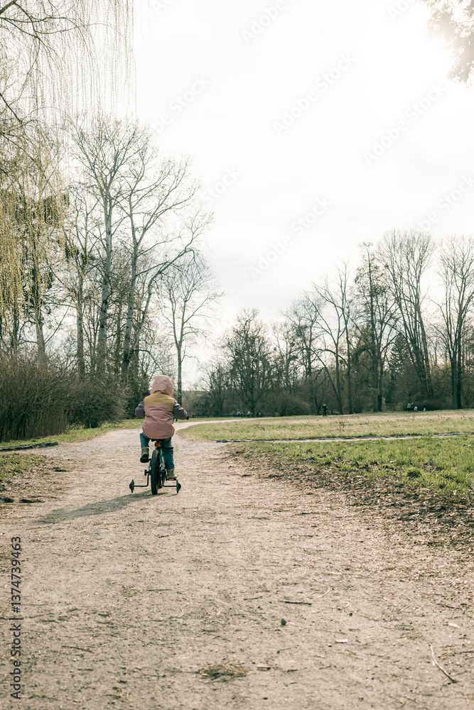 Kid enjoys spring cycling in green park Kid enjoys spring cycling in green park
