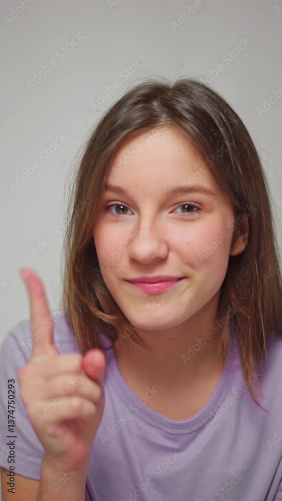 custom made wallpaper toronto digitalClose-up studio shot of a girl playfully wagging her finger with a mischievous smile, as if teasing, on a white isolated background