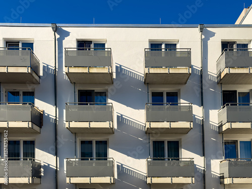 Obraz na plátně Modern apartment building with balconies under a clear sky