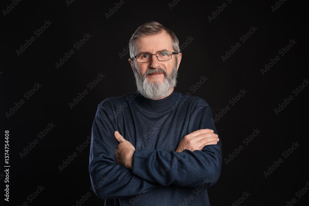 Portrait of mature man with crossed arms on black background Portrait of mature man with crossed arms on black background