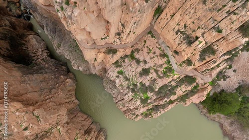 Caminito del Rey in Garganta Gorge, del Chorro, Spain. Aerial shot of a bridge in a narrow gorge, a river flows below. 