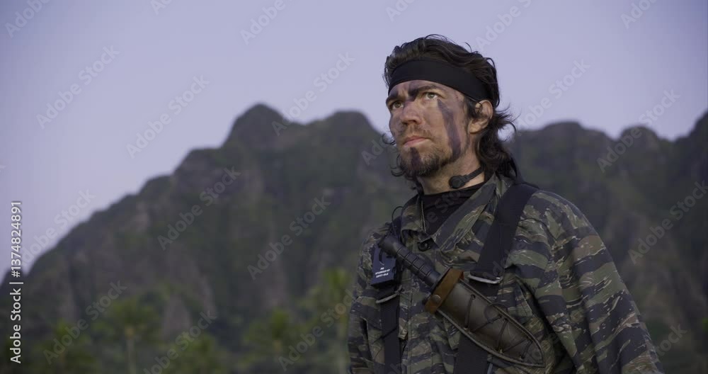 Guy in camouflage outfit discovering mysterious spiral artifact then looking around tropical area - low, handheld shot Guy in camouflage outfit discovering mysterious spiral artifact then looking around tropical area - low, handheld shot