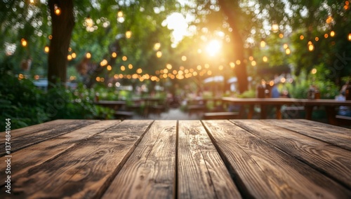 Empty wooden table outdoors at a garden restaurant at sunset