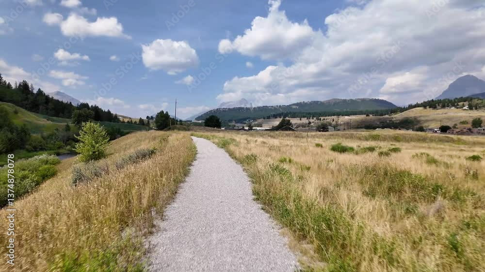Walking Path in Alberta, Canada: Mountains, Blue Skies, and Clouds Walking Path in Alberta, Canada: Mountains, Blue Skies, and Clouds