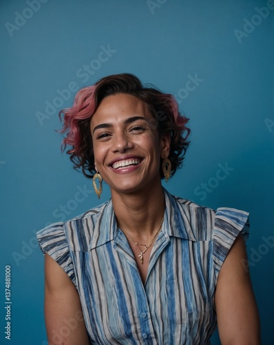 Transgender person smiling, blue background conveying joy and respect for diversity