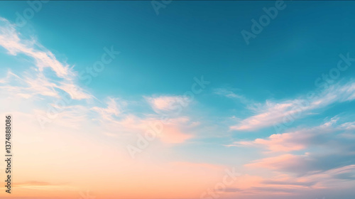 Fototapeta Naklejka Na Ścianę i Meble -  a clean summer sky with a gradient from deep blue at the top to a lighter blue near the bottom a few soft and wispy white clouds scattered subtle warm orange g