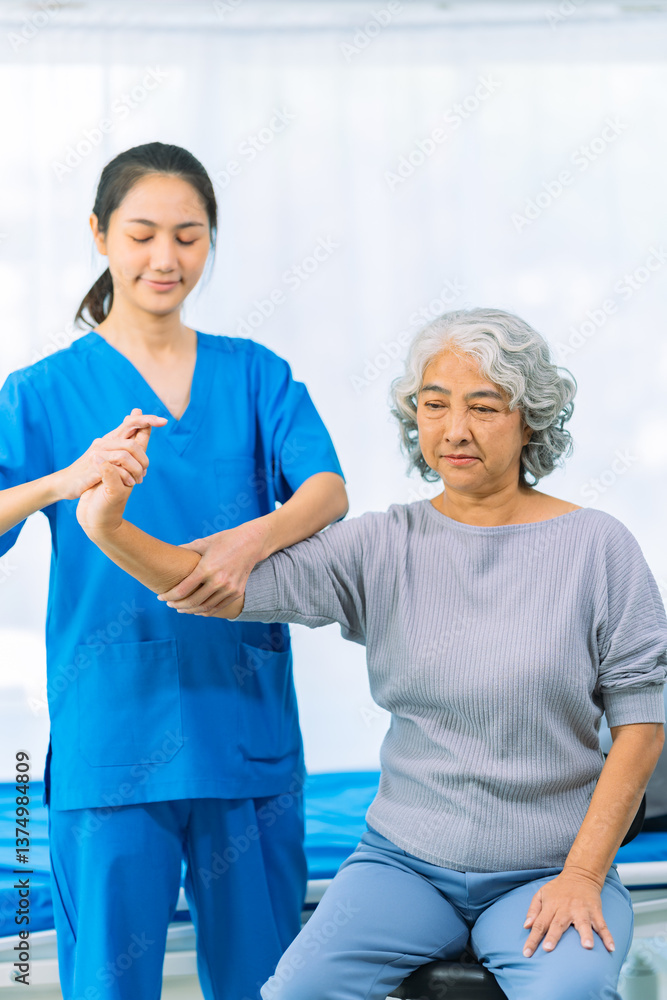Obraz premium Elderly woman receives medical services from home care nurse while performing muscle strengthening exercises.