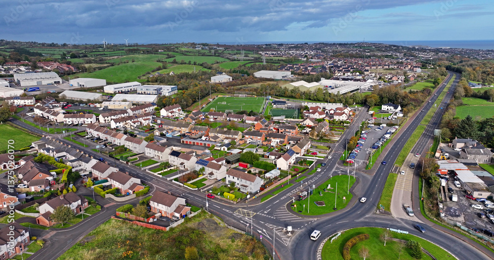 Fototapeta premium Aerial view of homes and businesses at Milbrook Roundabout Larne County Antrim Northern Ireland
