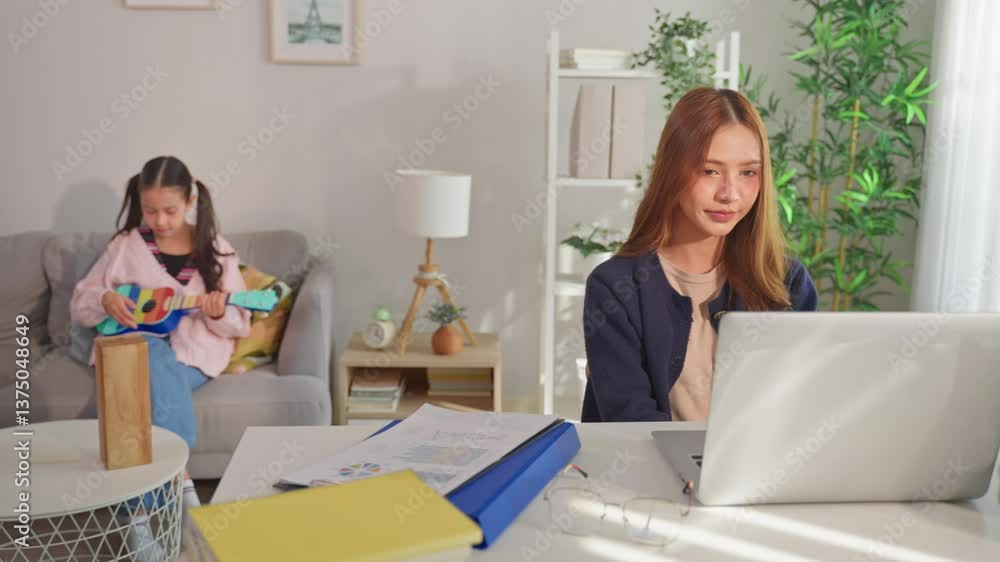 Asian young kid daughter feeling sad and need to play with busy mother. Asian young kid daughter feeling sad and need to play with busy mother.