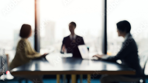 Blurred image of a group of business people having a meeting in an office