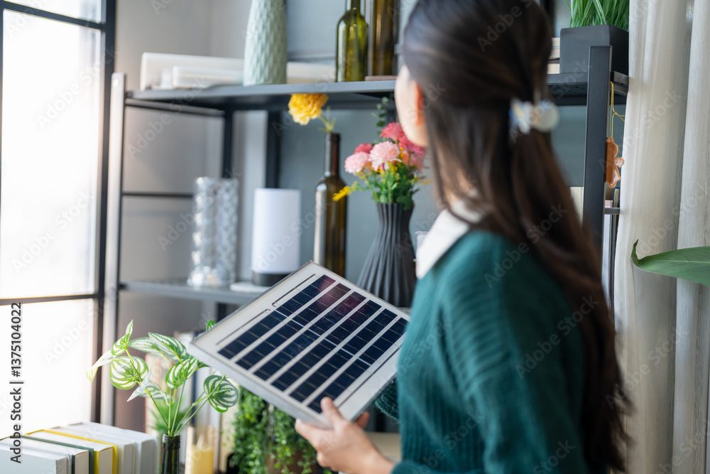 Home owner install solar power systems in her house Asian Woman learning about sustainable technology Home owner install solar power systems in her house Asian Woman learning about sustainable technology