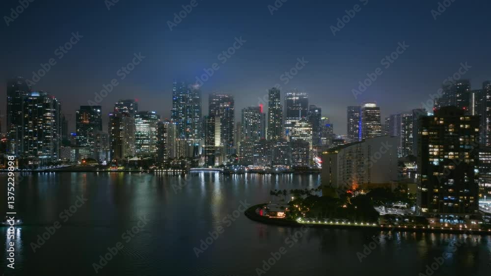 Experience the stunning nighttime skyline of Downtown Miami and Brickell Key, where the citys beauty shines brightly under the enchanting night sky filled with vibrant colors and reflections Experience the stunning nighttime skyline of Downtown Miami and Brickell Key, where the citys beauty shines brightly under the enchanting night sky filled with vibrant colors and reflections
