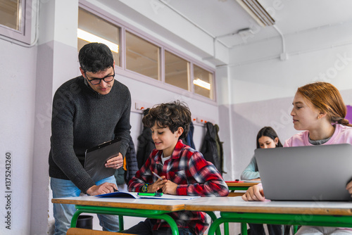 Εκτύπωση καμβά Teacher helping young student with schoolwork in classroom