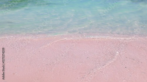 ocean with calm waves reaching shore of pink sand beach on tropical during sunny day, holidays, vacations, relax, paradise and tourism concept