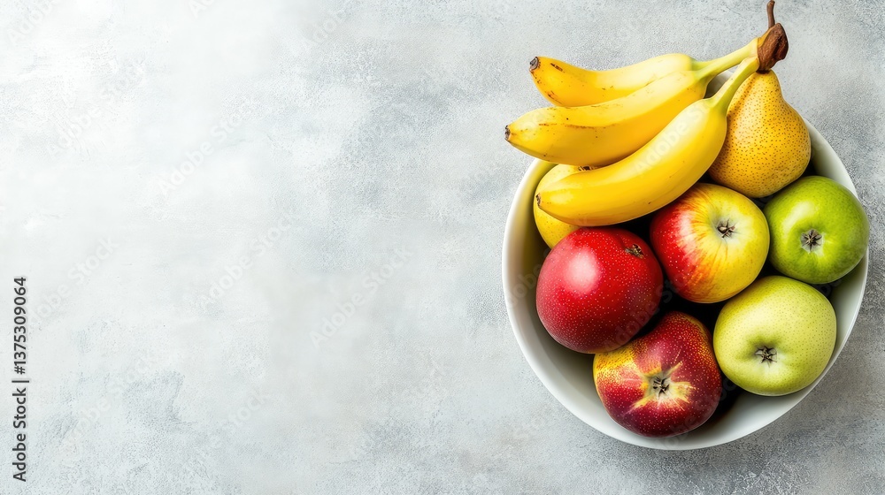 Organic apples, pears, and bananas arranged in a storage bowl on a clean countertop with clear space for copy above.