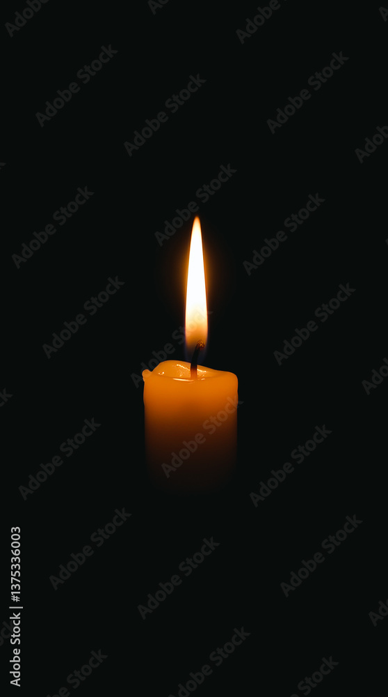 Burning candle on black background with space for text. For themes related to remembrance, mourning, loss or spirituality, hope and keeping the fire of life burning. Burning candle on black background with space for text. For themes related to remembrance, mourning, loss or spirituality, hope and keeping the fire of life burning.