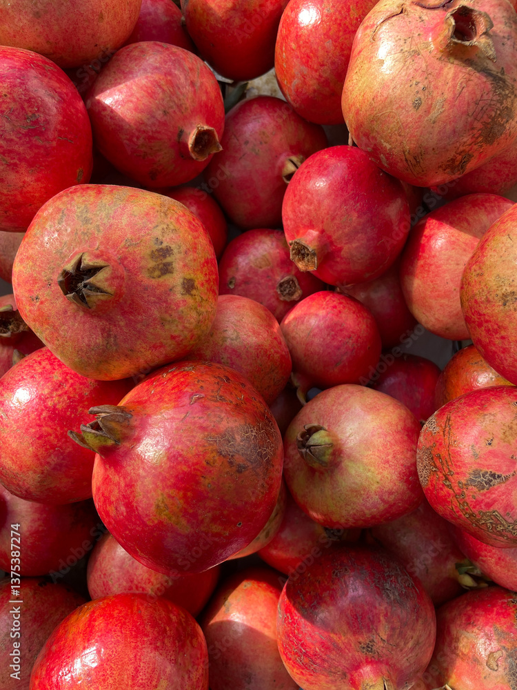 lots of ripe red pomegranate fruits for cooking as background lots of ripe red pomegranate fruits for cooking as background