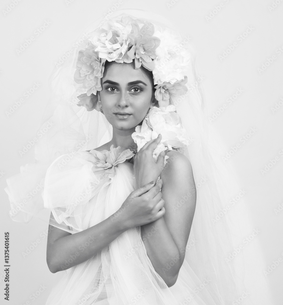 Indian female model dressed as a bride with floral head gear.