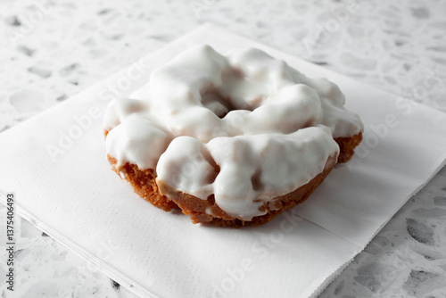 A view of a vanilla frosting old-fashioned donut.
